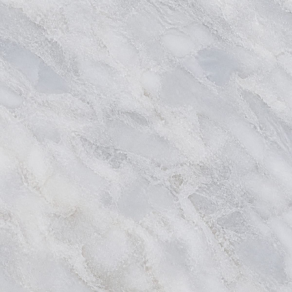 Close-up of a honed Super White dolomite countertop, cool white-grey with soft cloudy blue-grey drifting movement
