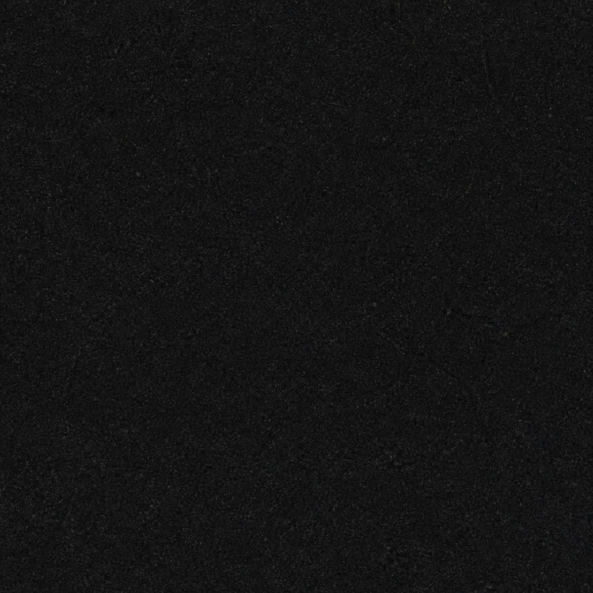 Close-up of a honed Absolute Black granite countertop, uniformly deep black with an extremely fine even grain