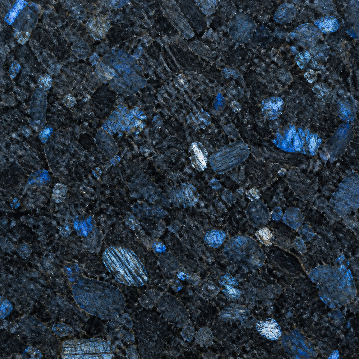 Close-up of a polished Blue Pearl granite countertop, deep blue-grey with iridescent labradorite crystals flashing blue and silver
