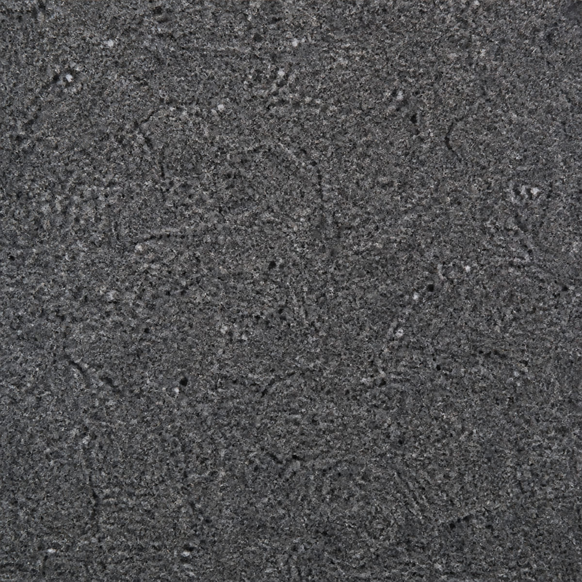 Close-up of a leathered Steel Grey granite countertop, charcoal with dense fine silver and pewter flecking and a soft textured sheen
