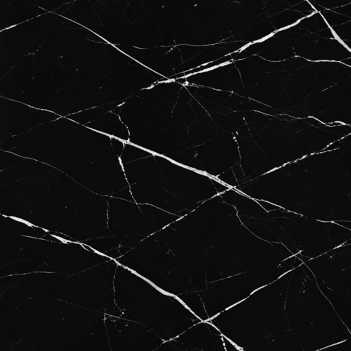 Close-up of a polished Nero Marquina marble countertop, deep black with sharp crisp white angular veining