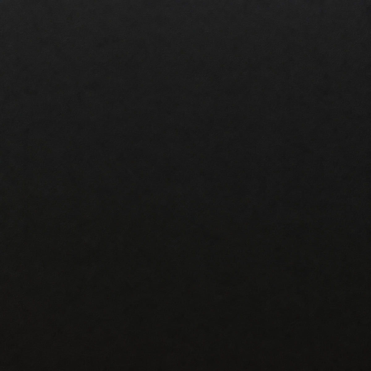 Close-up of a matte black porcelain countertop, uniformly deep black with no pattern