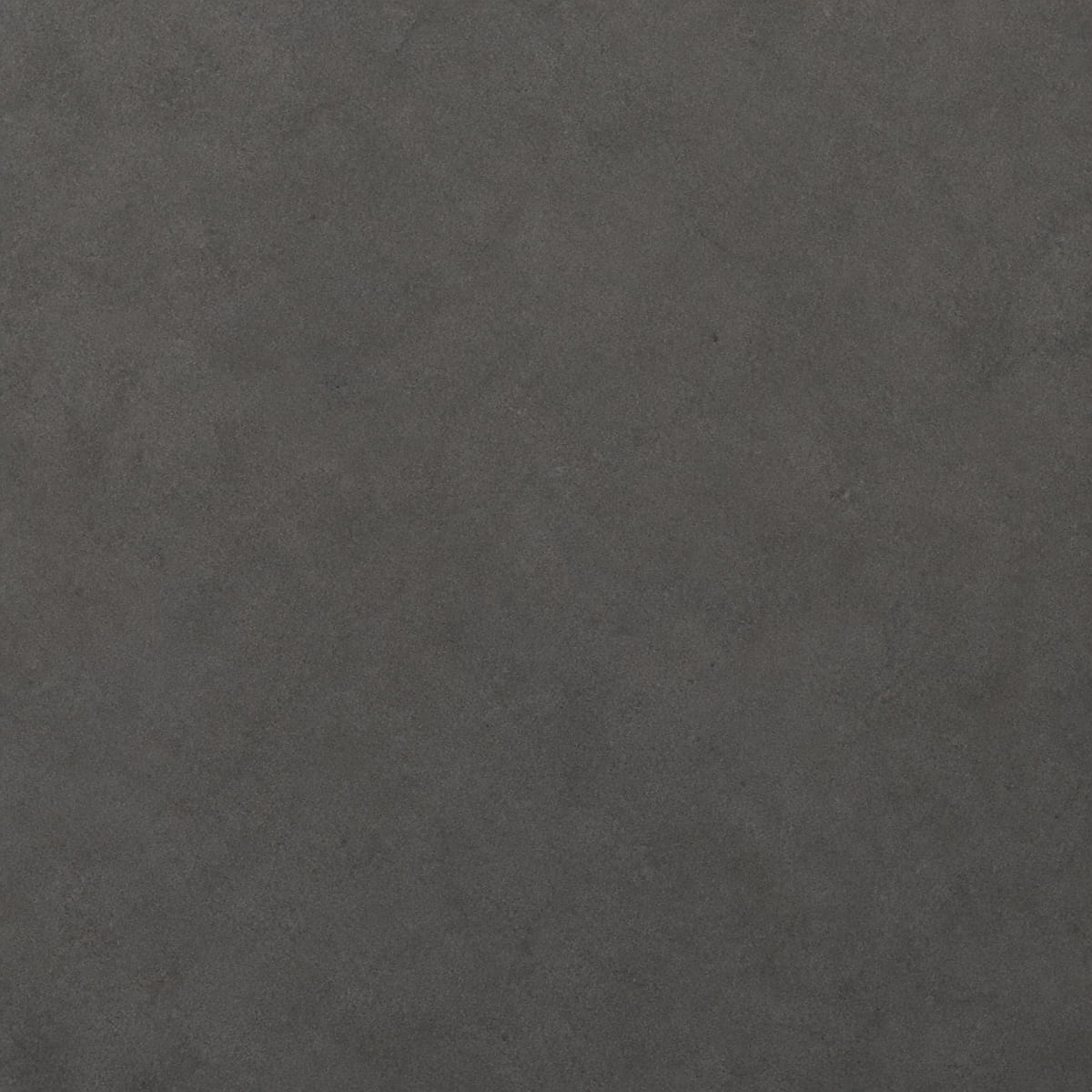 Close-up of a matte charcoal grey quartz countertop with a concrete-like mottled texture and no veining