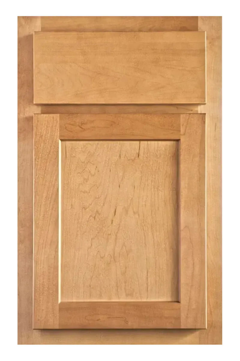 Wellborn Forest Devon cabinet door in maple with a wheat stain — a half overlay flat panel door with a stepped bevel, showing the face frame around it